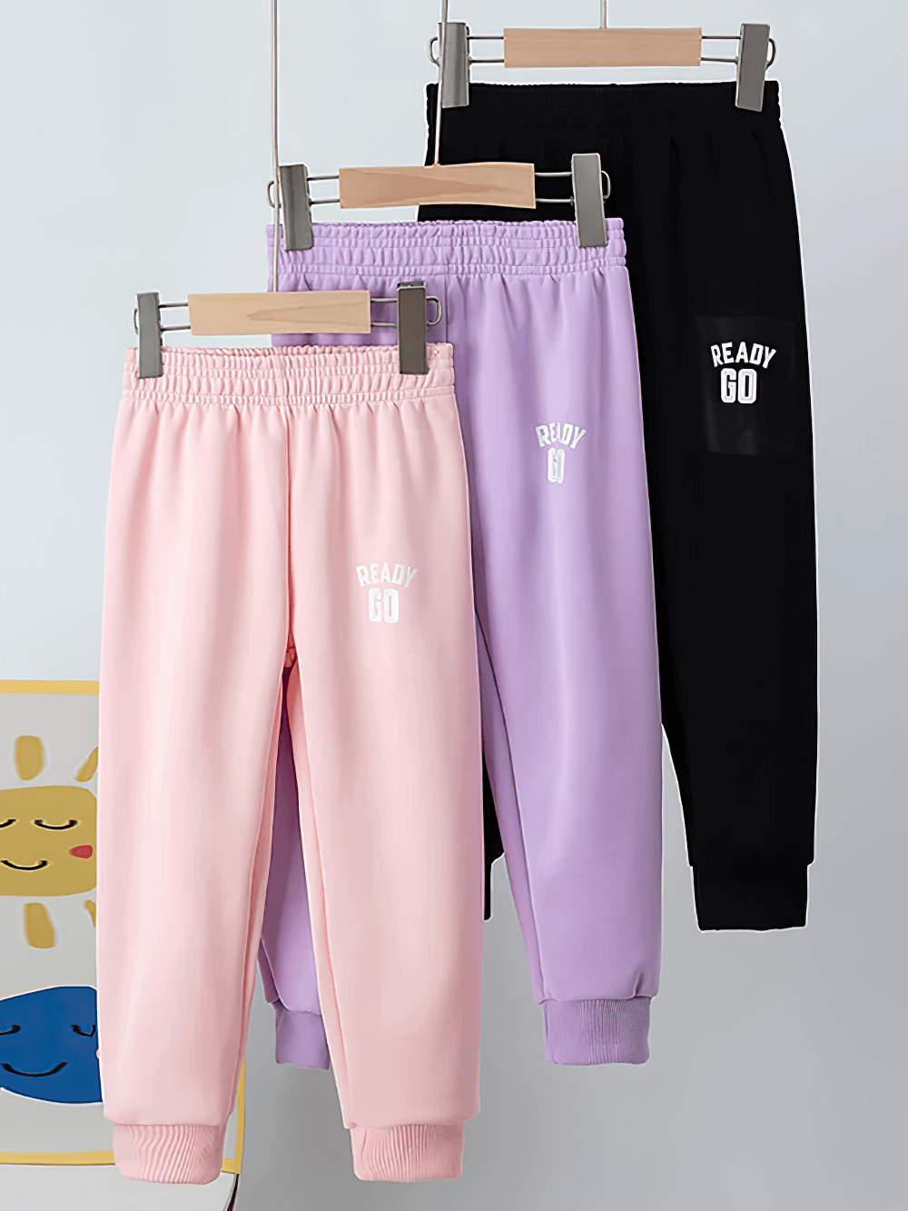 Kids Elastic Ankle Sport Pants Ready Go Print - SF3880 pastel and black collection on hangers.