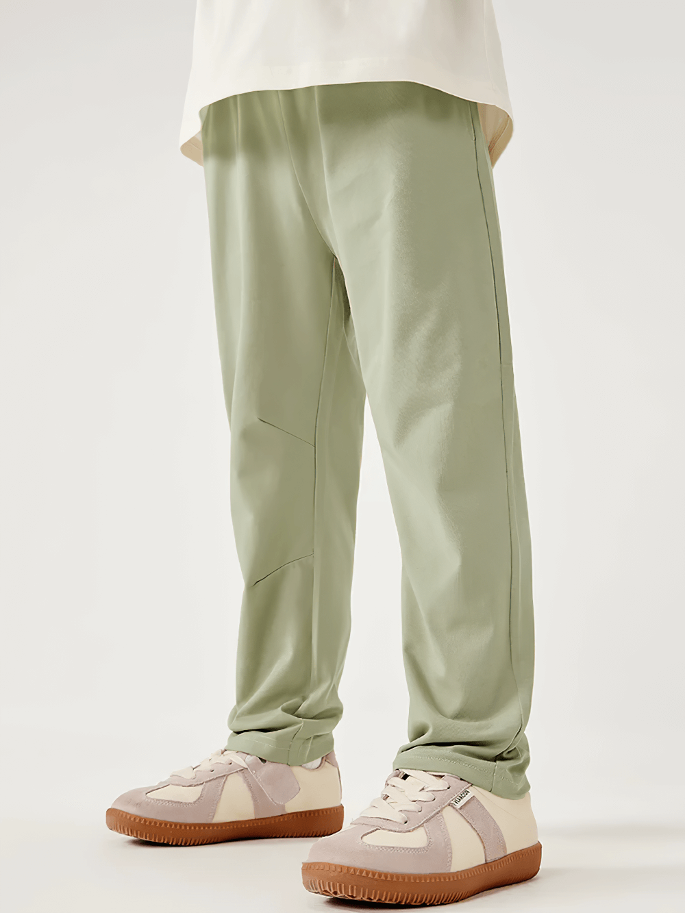 Child wearing Kids Elastic Waist Soft Cotton Sport Pants - SF3800 in light green for comfortable play.