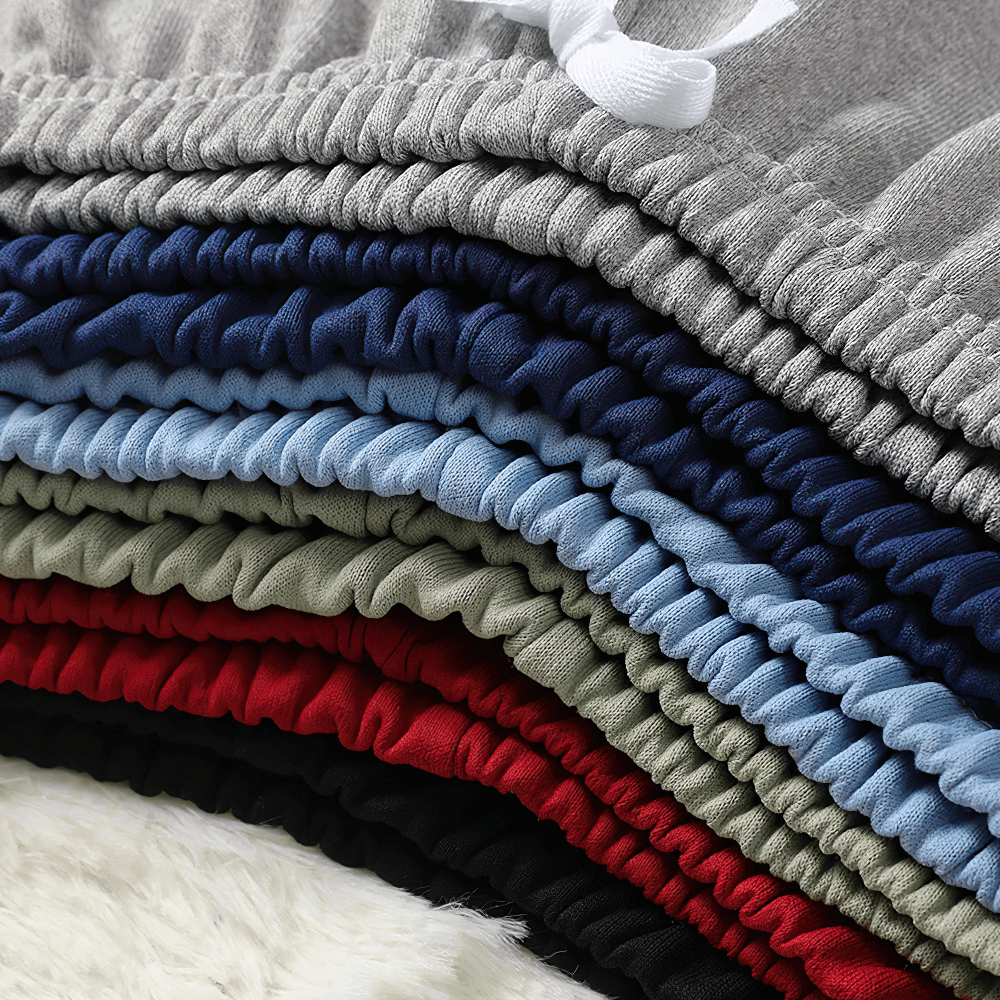 Stack of multi-color Kids Elastic Waist Sport Jogger Pants SF3861 showcasing elastic waistbands and stylish design.