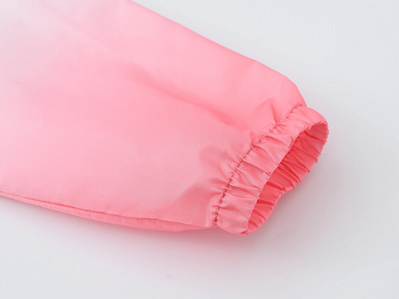Close-up of elastic cuff on Kids Gradient Hooded Windbreaker with Zipper - SF3652 in light pink, showcasing breathable fabric detail.