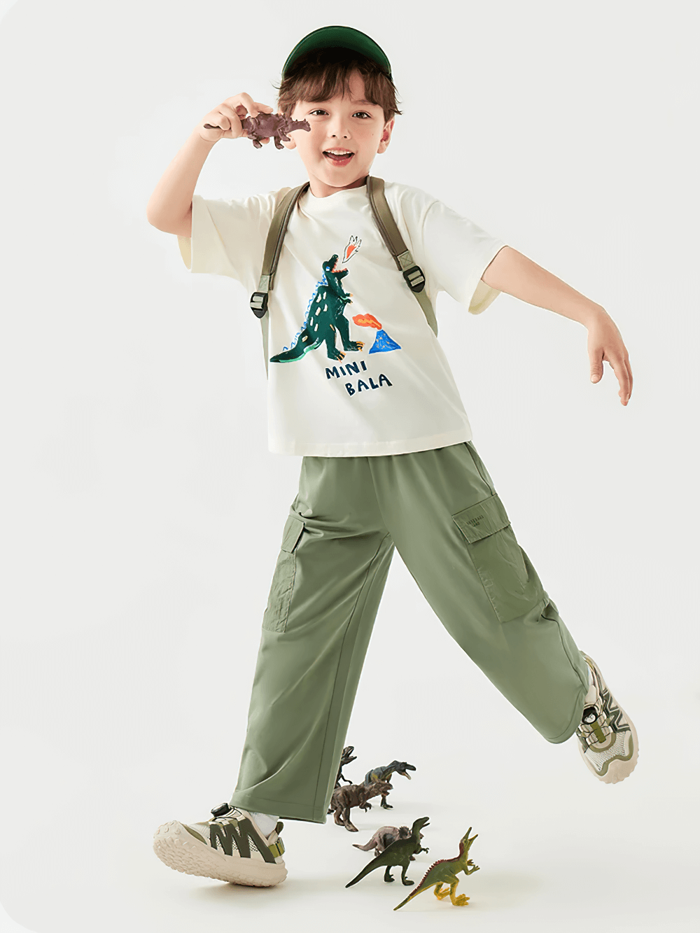 Child playing in Kids Hiking Pants with Elastic Waist and Pockets - SF3802, showcasing outdoor fun and flexibility with toys around.