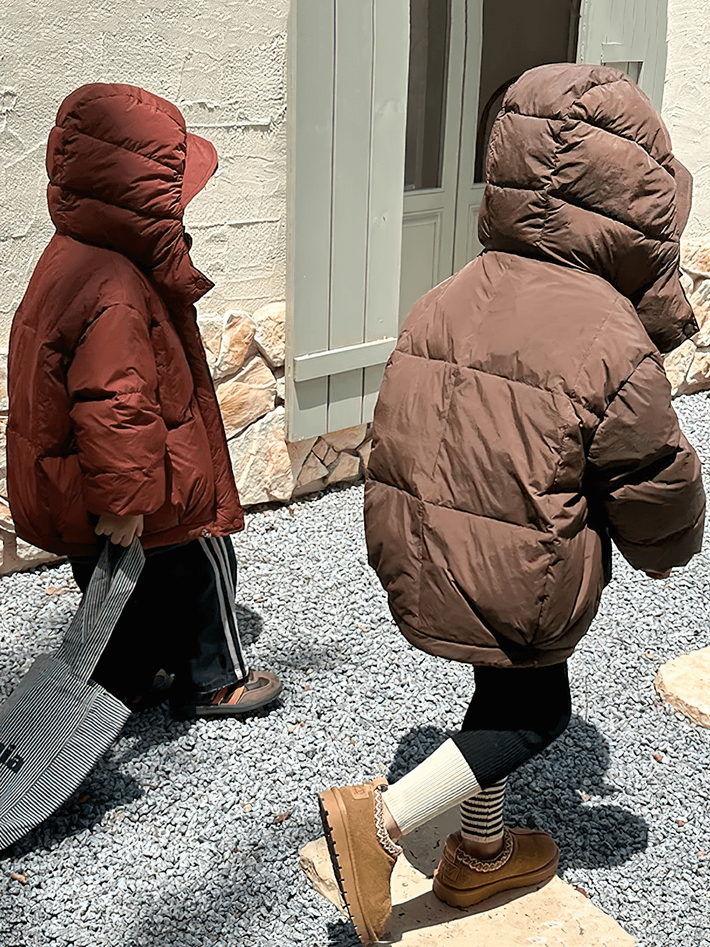 Two children wearing Kids Hooded Down Jacket With Warm Thicken Padding - SF3809 walking outdoors in winter.