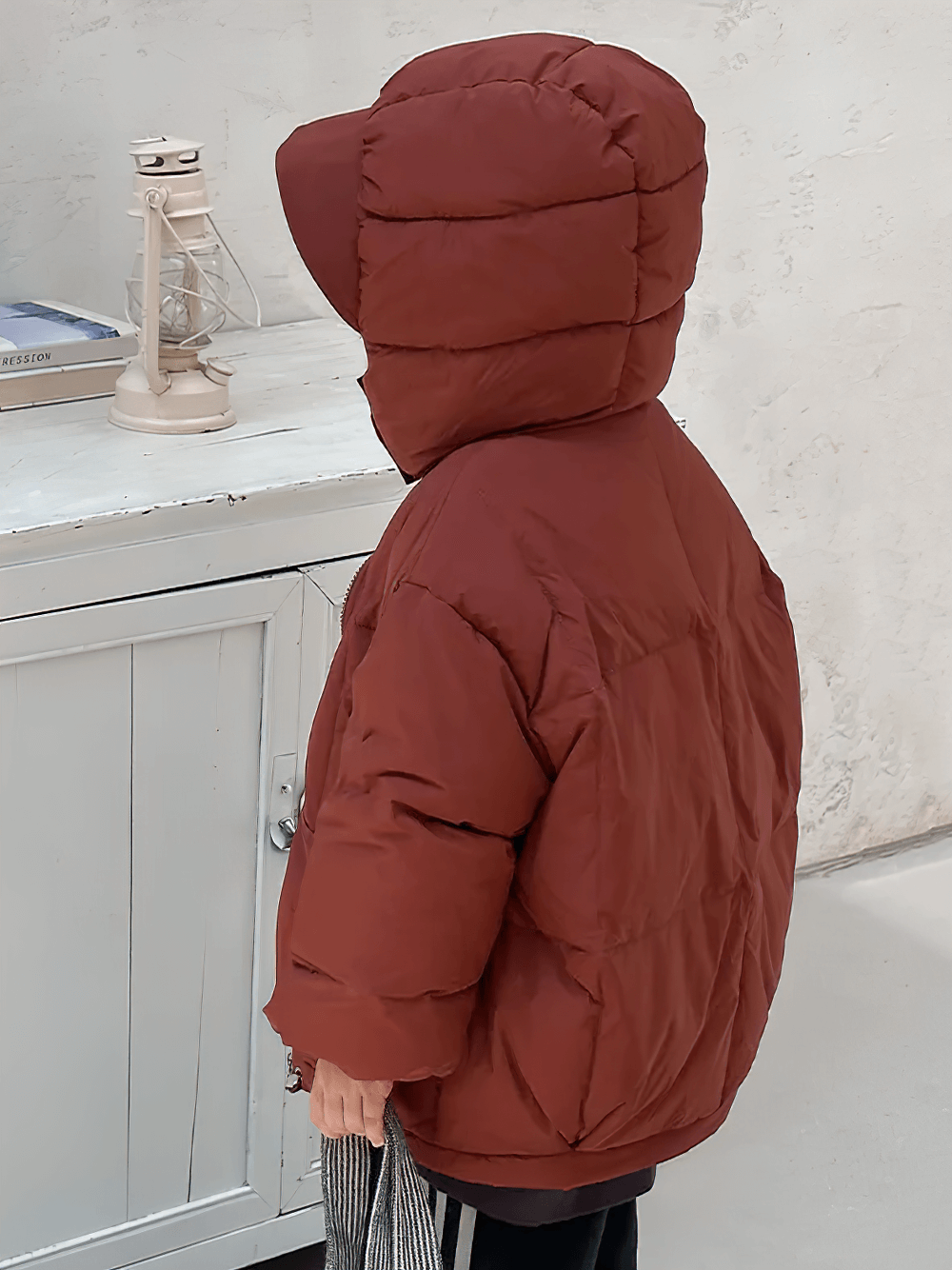 Child wearing Kids Hooded Down Jacket With Warm Thicken Padding - SF3809, standing indoors, showcasing cozy winter style.