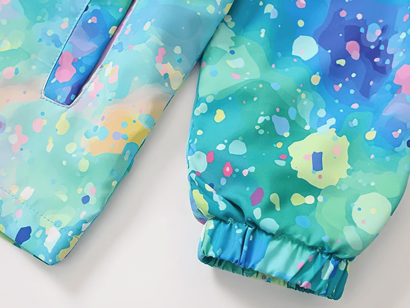 Close-up of Kids Hooded Jacket with Colorful Graffiti Print - SF3606 showing vibrant pattern and elastic cuff detail.