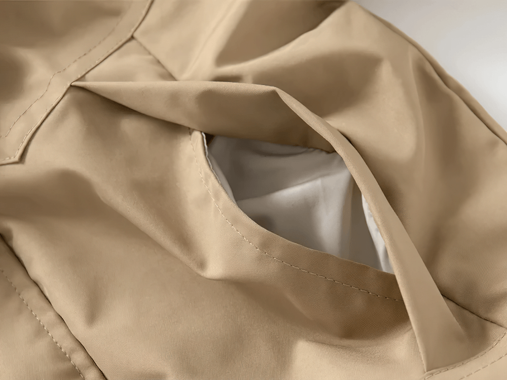 Close-up of side pocket on Kid's Lightweight Hooded Windbreaker - SF3549 in beige, showcasing fabric detail and craftsmanship.