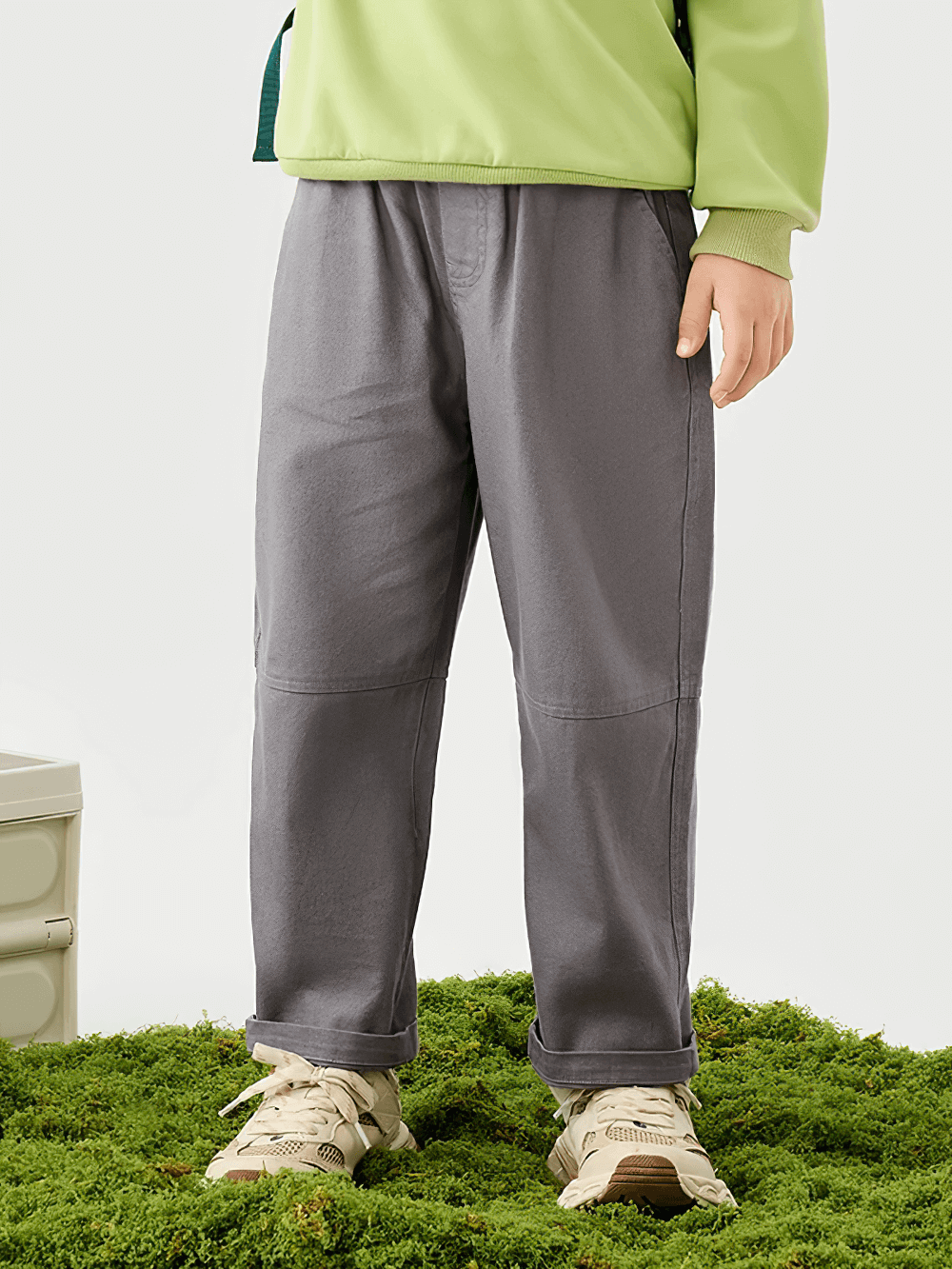 Child wearing Kids Loose Sport Trousers with Elastic Waist - SF3801, standing on grass, showcasing the comfortable and practical design.