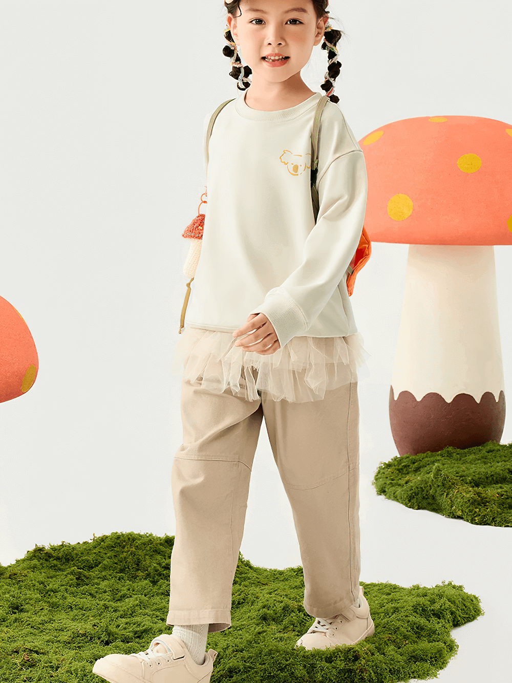 Child wearing Kids Loose Sport Trousers with Elastic Waist - SF3801, enjoying playtime with colorful mushroom backdrop