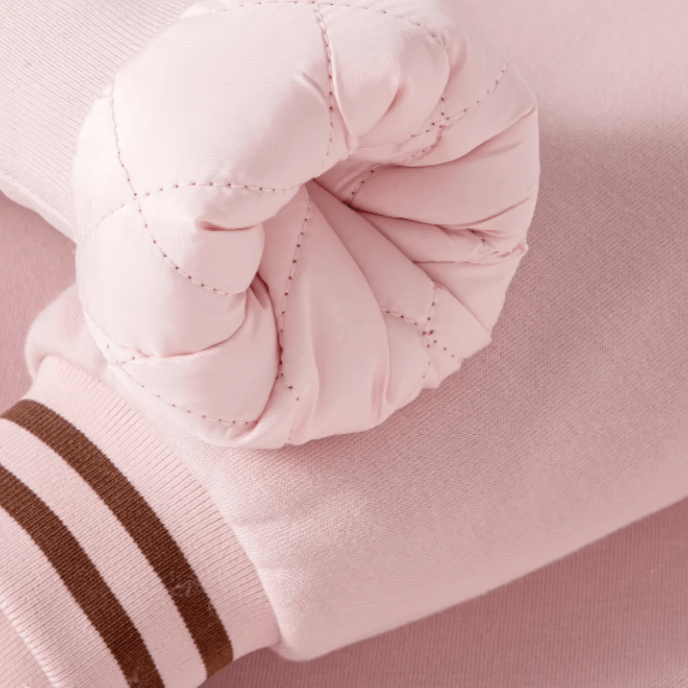 Close-up of sleeve on Kids Padded Baseball Jacket with Snap Buttons - SF3866 featuring quilted design and striped cuff, in soft pink.