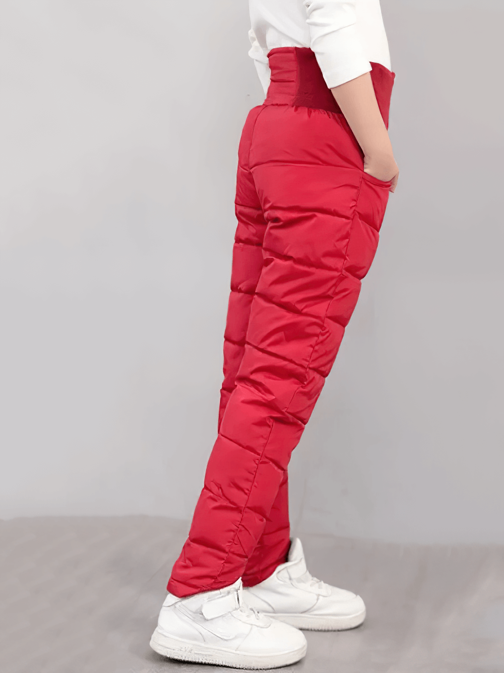Child wearing Kids Padded Pants with Elastic High Waist - SF3753, showcasing thick waterproof design in vibrant red for cold weather.