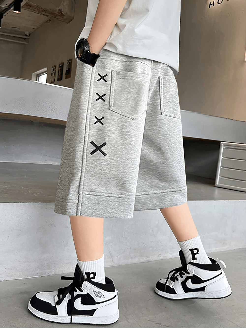 Kid wearing Kids Print Loose Fit Soft Shorts With Pockets - SF3878, featuring side stripe and X graphic, perfect for active play.