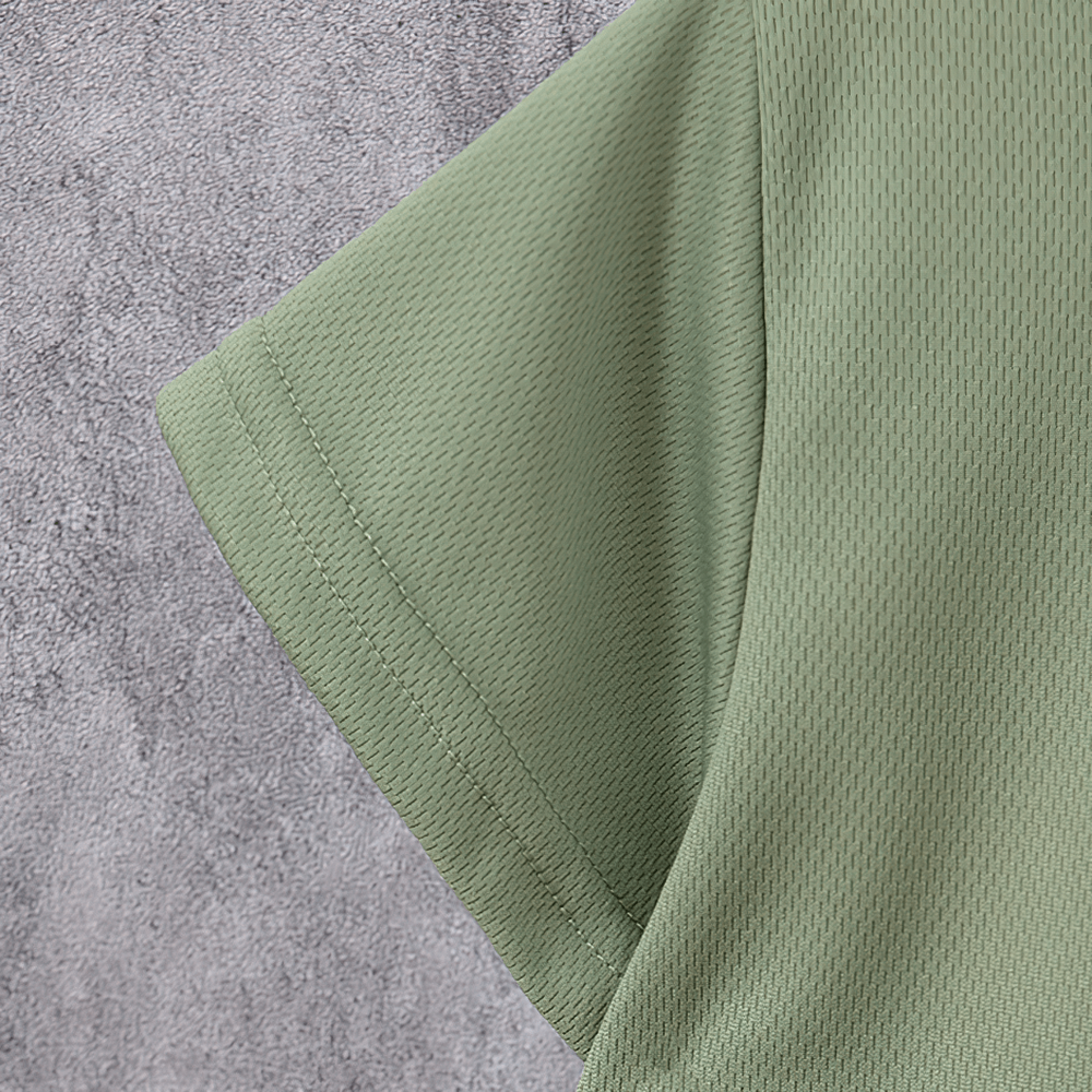 Close-up of a kids' quick-drying green sports T-shirt sleeve, showcasing breathable fabric texture.