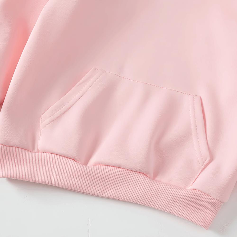 Close-up of a pink kids pullover hoodie showcasing its stylish front pocket and ribbed hem, perfect for casual everyday wear.