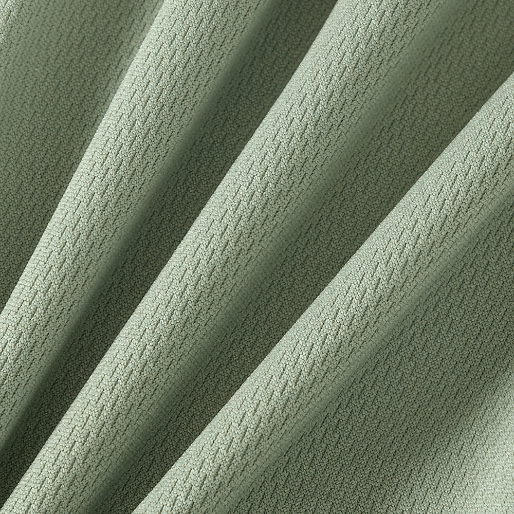 Close-up of light green quick-drying sport fabric, showcasing breathable texture and zigzag pattern perfect for active kids' wear.
