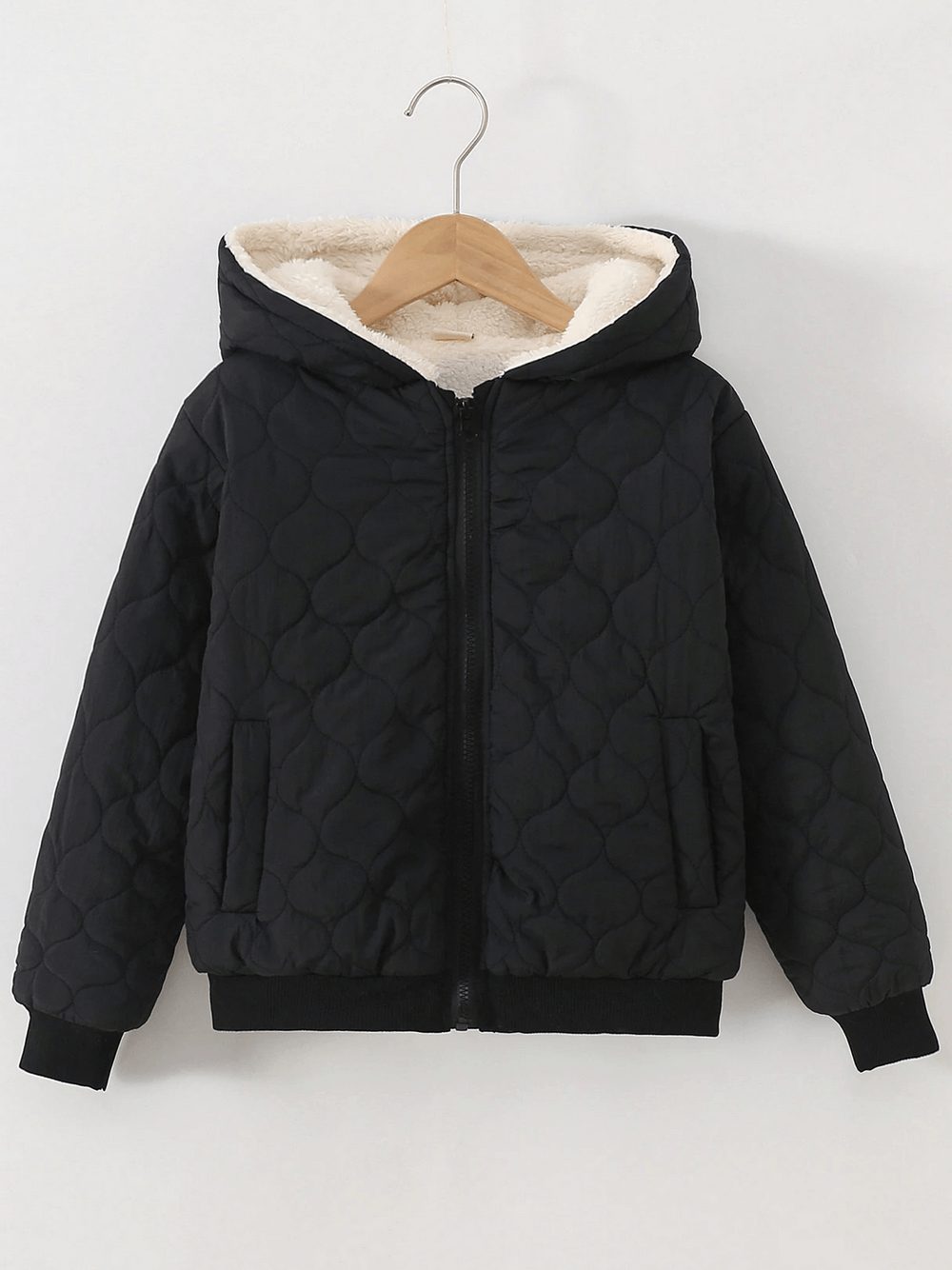Black Kids Quilted Hooded Jacket with Warm Sherpa Lining - SF3898 on a hanger, showcasing fleece interior and quilted pattern.