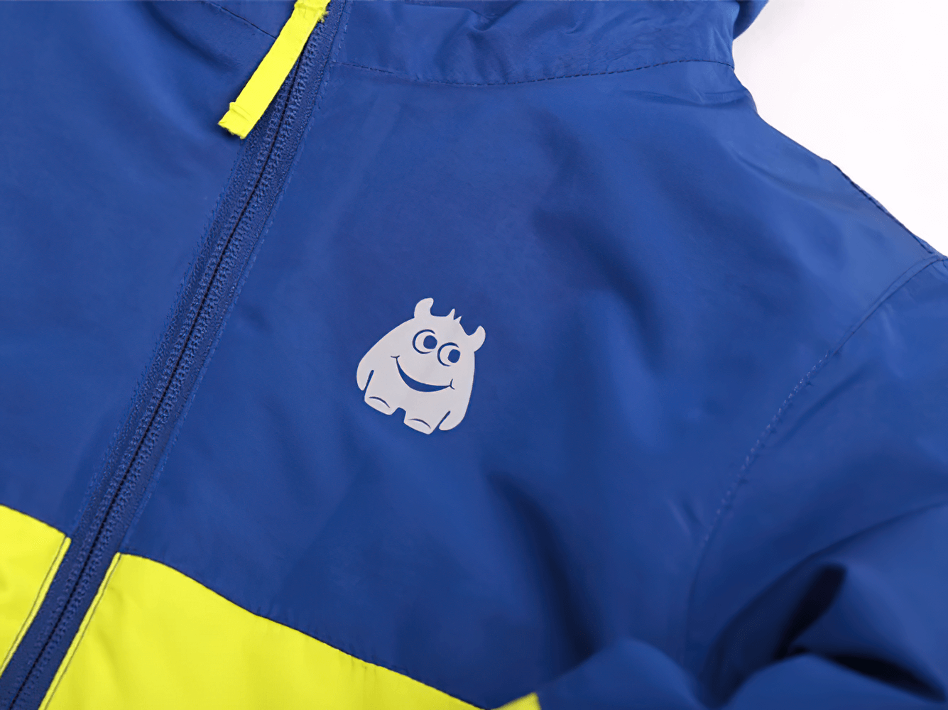 Blue and yellow Kids Ski Jacket with Hood and Elastic Cuffs - SF3580 featuring a playful monster graphic on the front.