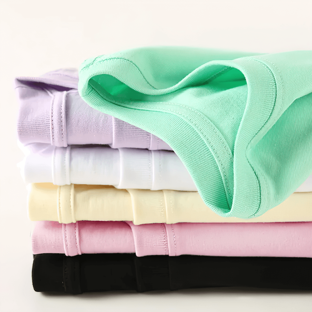 Stack of kids solid color short-sleeved cotton T-shirts in pastel shades, showcasing SF3121 variety.