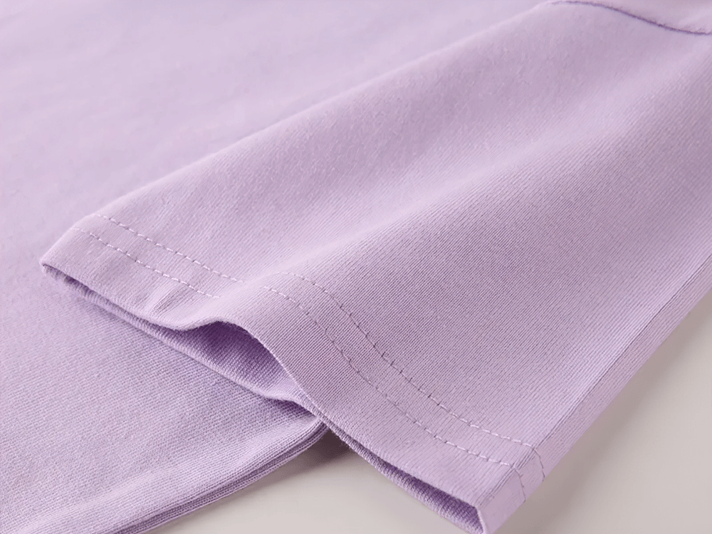 Close-up of Kids Solid Color Short-Sleeved Cotton T-shirt in lavender, showcasing soft fabric and stitching details.