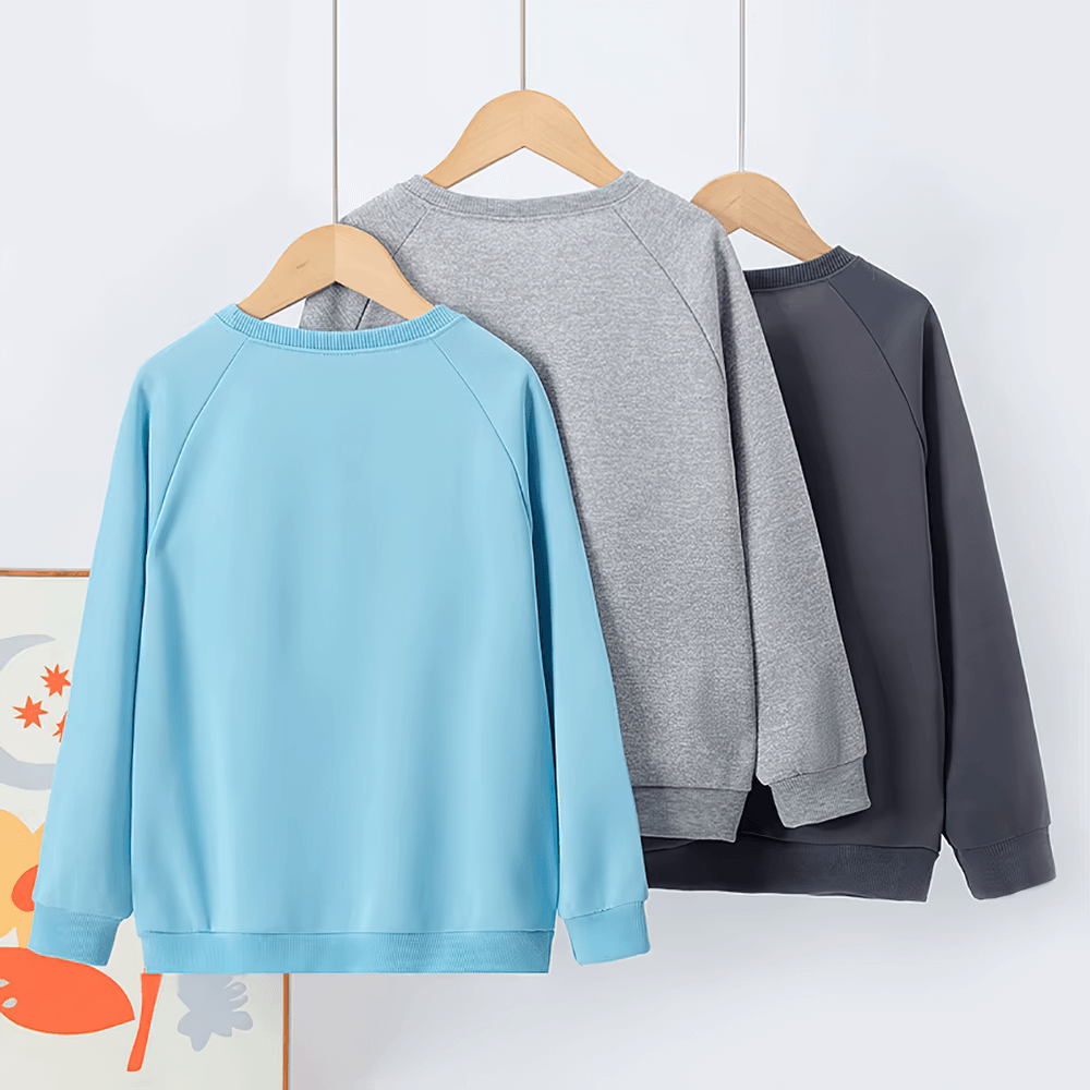 Kids solid color sweatshirts in blue, gray, and black hanging on wooden hangers, perfect for everyday wear and leisure sports activities.