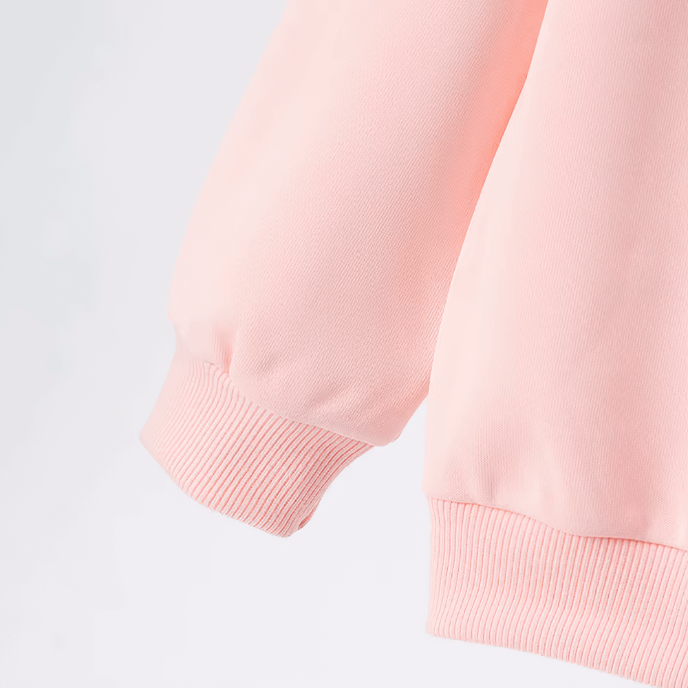 Close-up of a kids' solid color sweatshirt sleeve in pink, highlighting the soft, ribbed cuff. Perfect for everyday wear and sports.