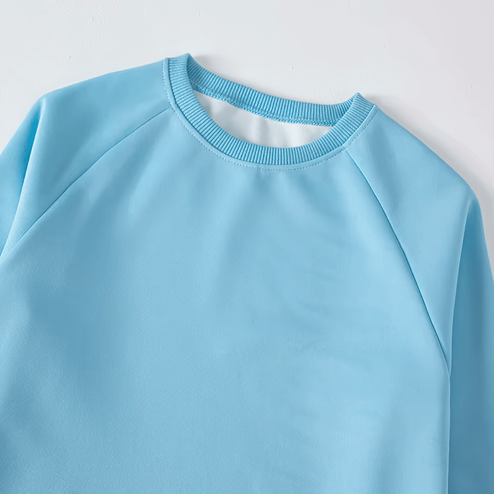 Light blue kids' solid color sweatshirt, long sleeves, perfect for everyday wear and sports. SF3093, durable polyester, breathable comfort.