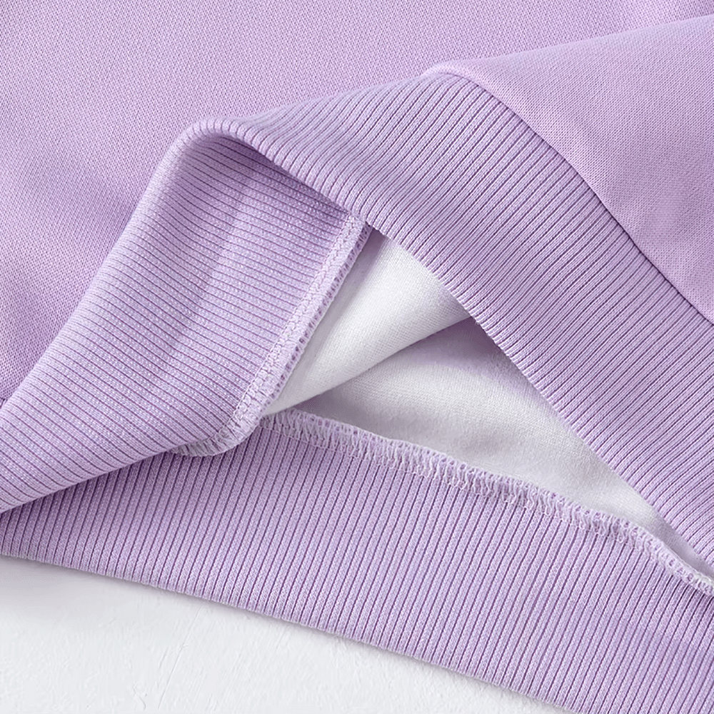 Purple kids solid color sweatshirt showing ribbed cuffs and hem for everyday wear and sports activities. Comfortable and durable polyester fabric.