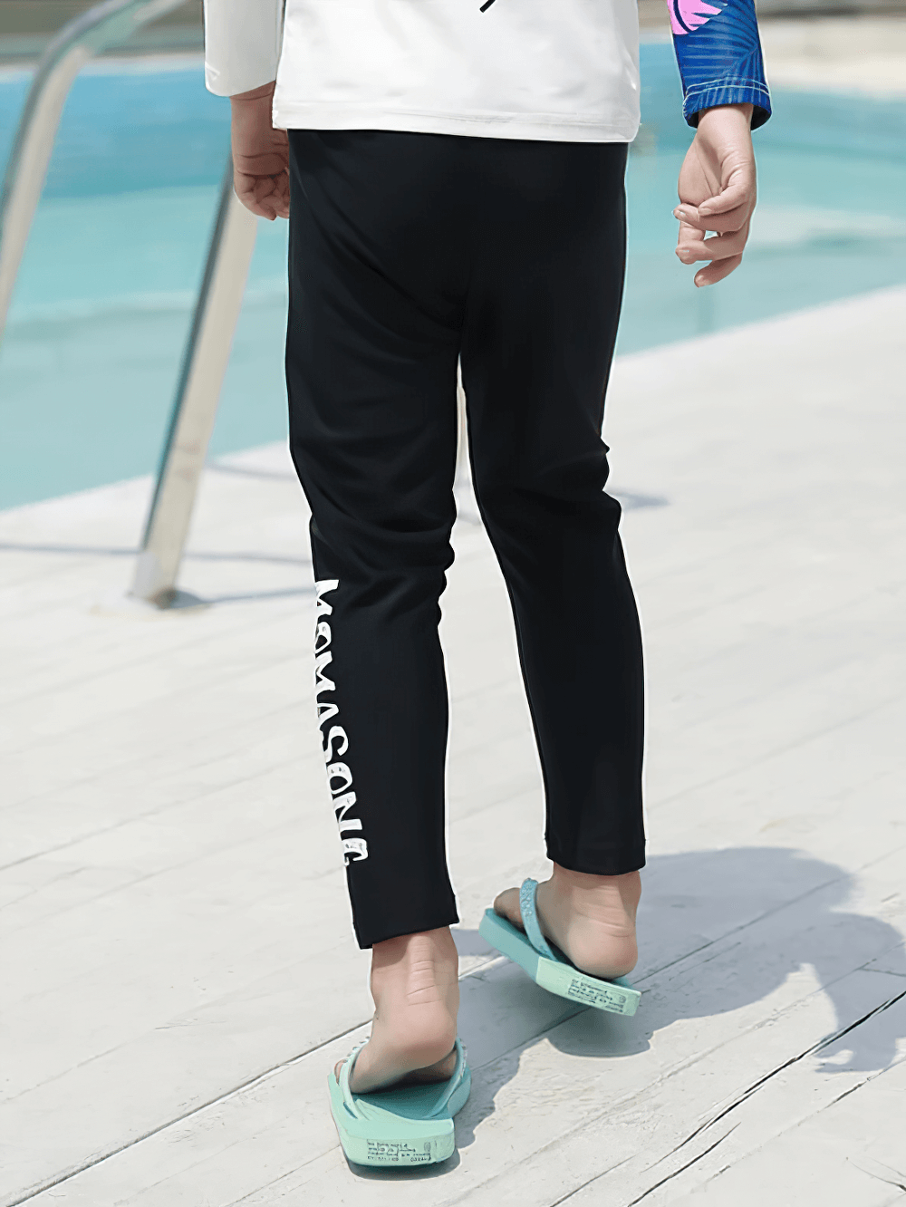 Kid wearing Kid's Sport Long Pants with Quick Dry Fabric - SF3586 by the pool, showing elastic waist and sun-protection fabric.