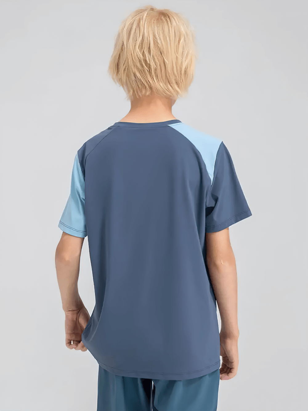 Child wearing Kids Sport T-Shirt with Mixed Color Raglan Sleeves - SF3856, showing back view and color contrast of the sleeves.