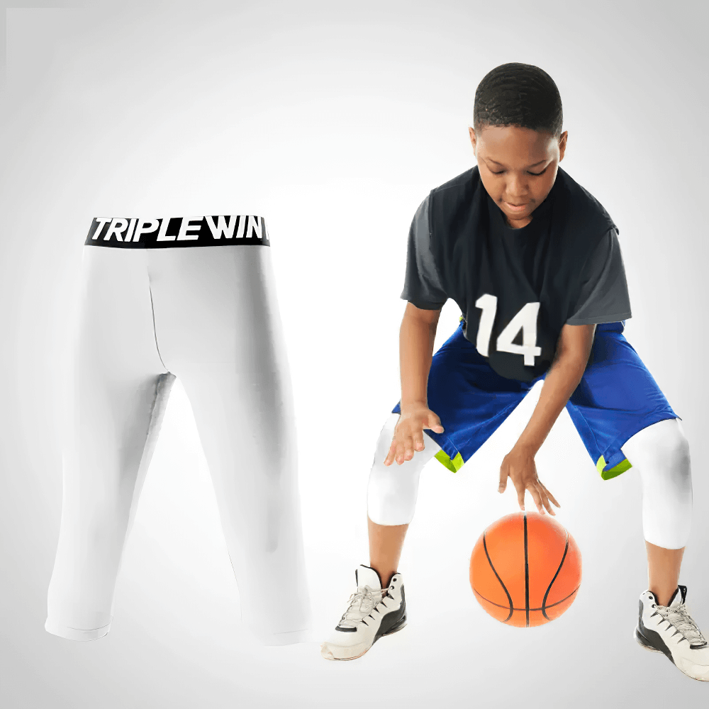Young athlete wearing Kids' Sports Capri Leggings for Fitness - SF3624 while playing basketball, showcasing flexibility and knee protection.