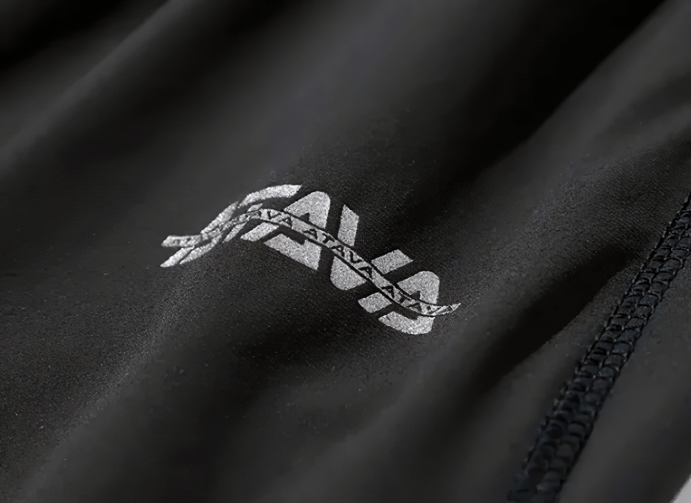 Close-up of logo on black fabric.
