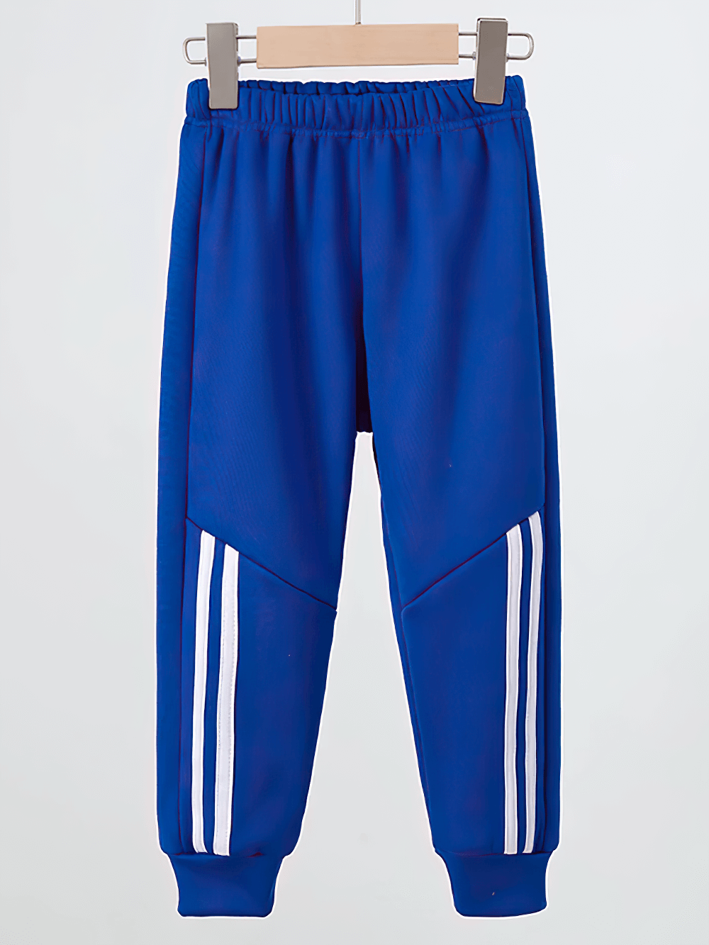 Kids Sports Pants with Plush Lining and Stripes - SF3837 in blue, with elastic waistband and white side stripes, hanging on a wooden hanger.