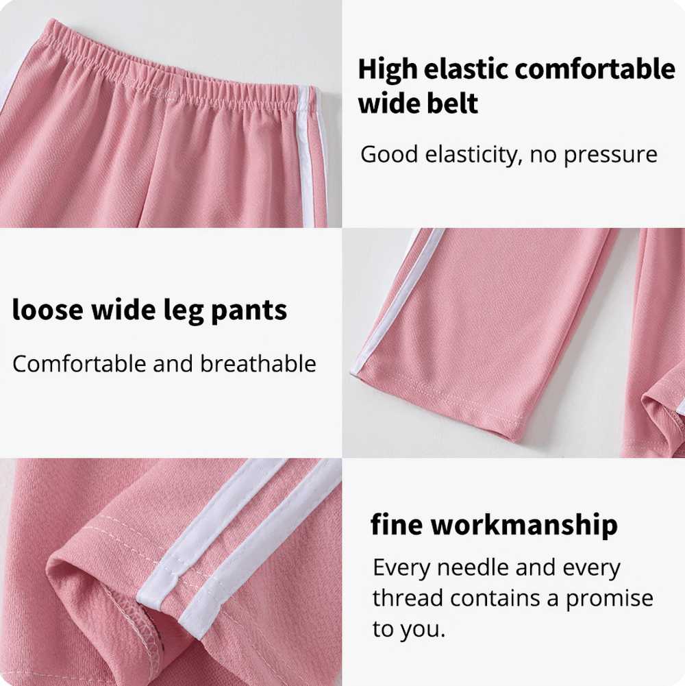 Close-up of pink kids sports pants showing elastic waist, wide legs, and white side stripe emphasizing comfort and fine workmanship.