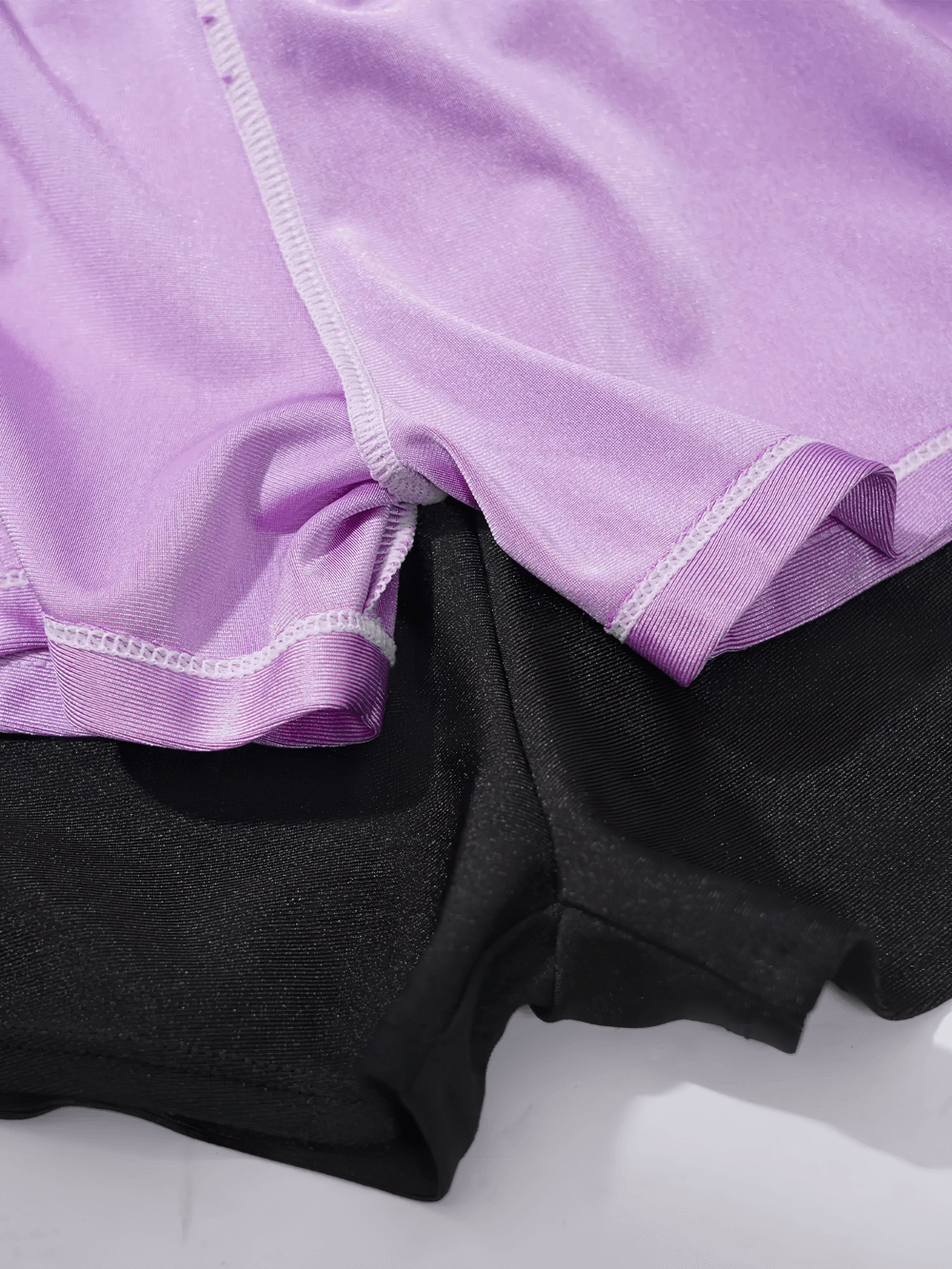 Close-up of Kids Sports Yoga Shorts with Double-Layer Design - SF3783 in lavender and black, showcasing elastic waistband and durable fabric.