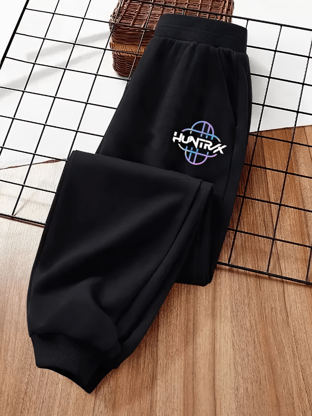 Kids Sporty Jogger Pants with Elastic Cuffs - SF3882 featuring sleek design and bold logo on wood and grid background.