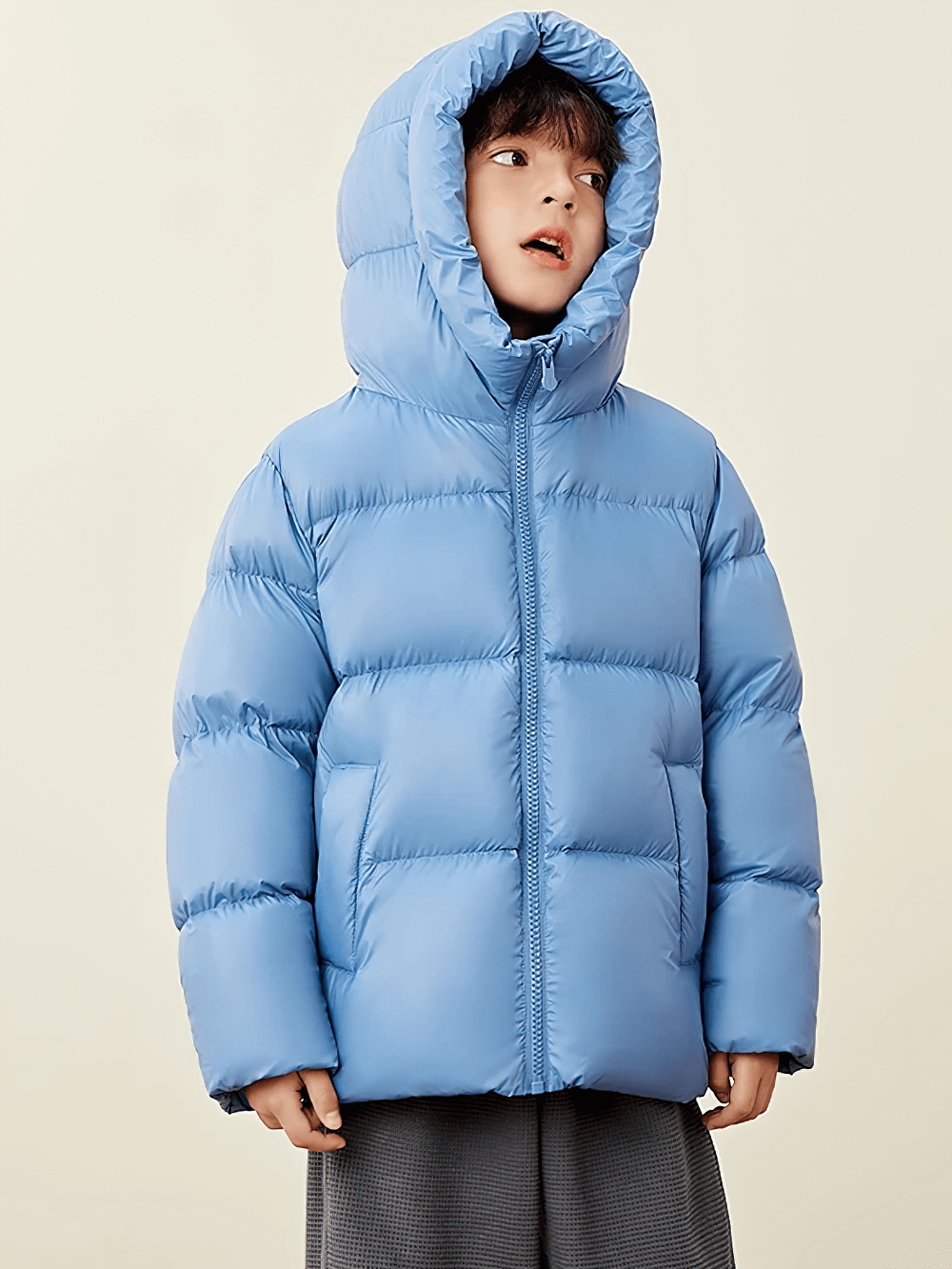 Child wearing a blue Kids Thermal Down Puffer Jacket with Hood - SF3695, featuring warm insulation and cozy hood for cold weather.