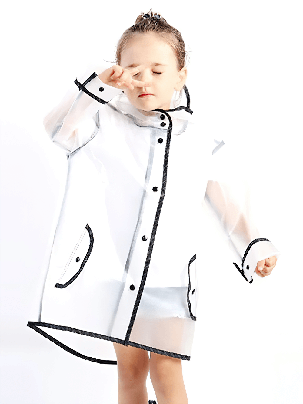 Child wearing Kids Transparent Long Hooded Raincoat - SF3671 with striped sleeves and pointed hood, enjoying a rainy day