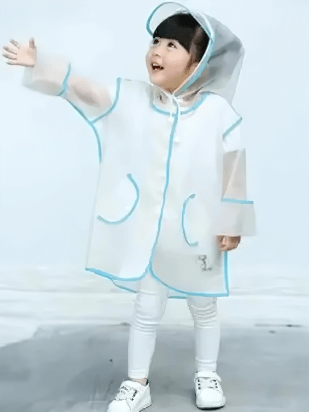 Child wearing Kids Transparent Long Hooded Raincoat - SF3671 with striped sleeves, smiling in stylish waterproof coat.