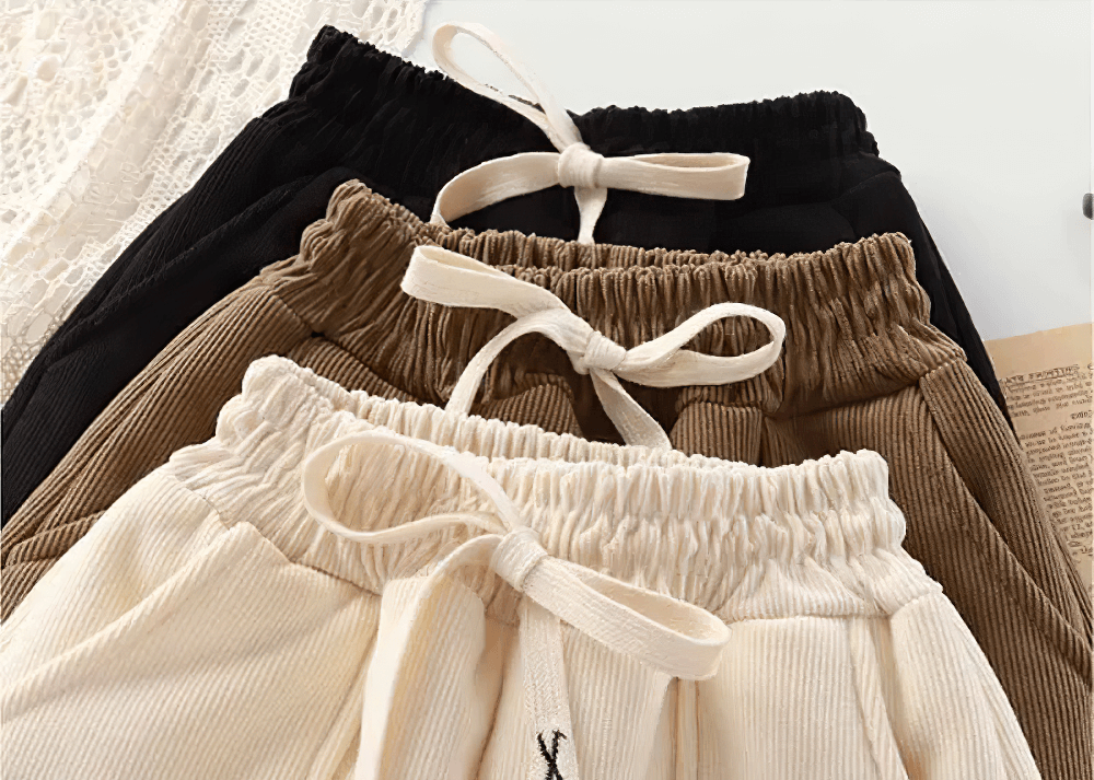 Variety of corduroy pants for kids with elastic waistbands and drawstrings, showing different color options for winter comfort and style.