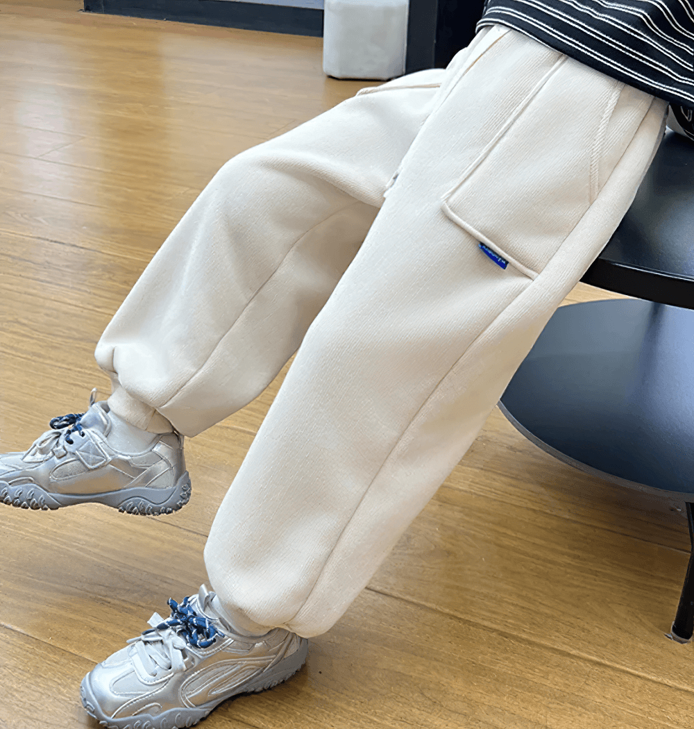 Child wearing Kids Warm Fleece Pants with Elastic Waist - SF3740 in beige for winter comfort, showcasing casual sporty style on wooden floor.