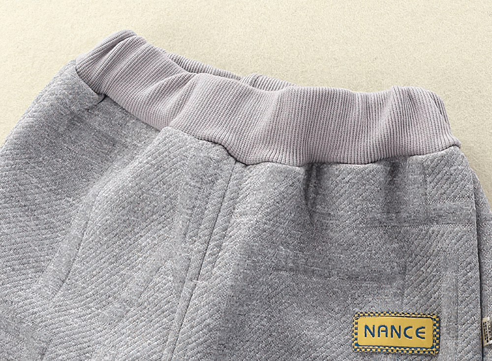 Close-up of grey Kids Warm Sport Jogger Pants with Elastic Waist - SF3884, showing fleece lining and ribbed waistband with yellow tag.