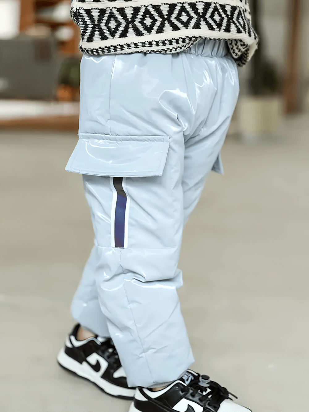 Child wearing Kids Waterproof Cargo Pants with Down Insulation - SF3779 in blue, showcasing large pockets and waterproof material.