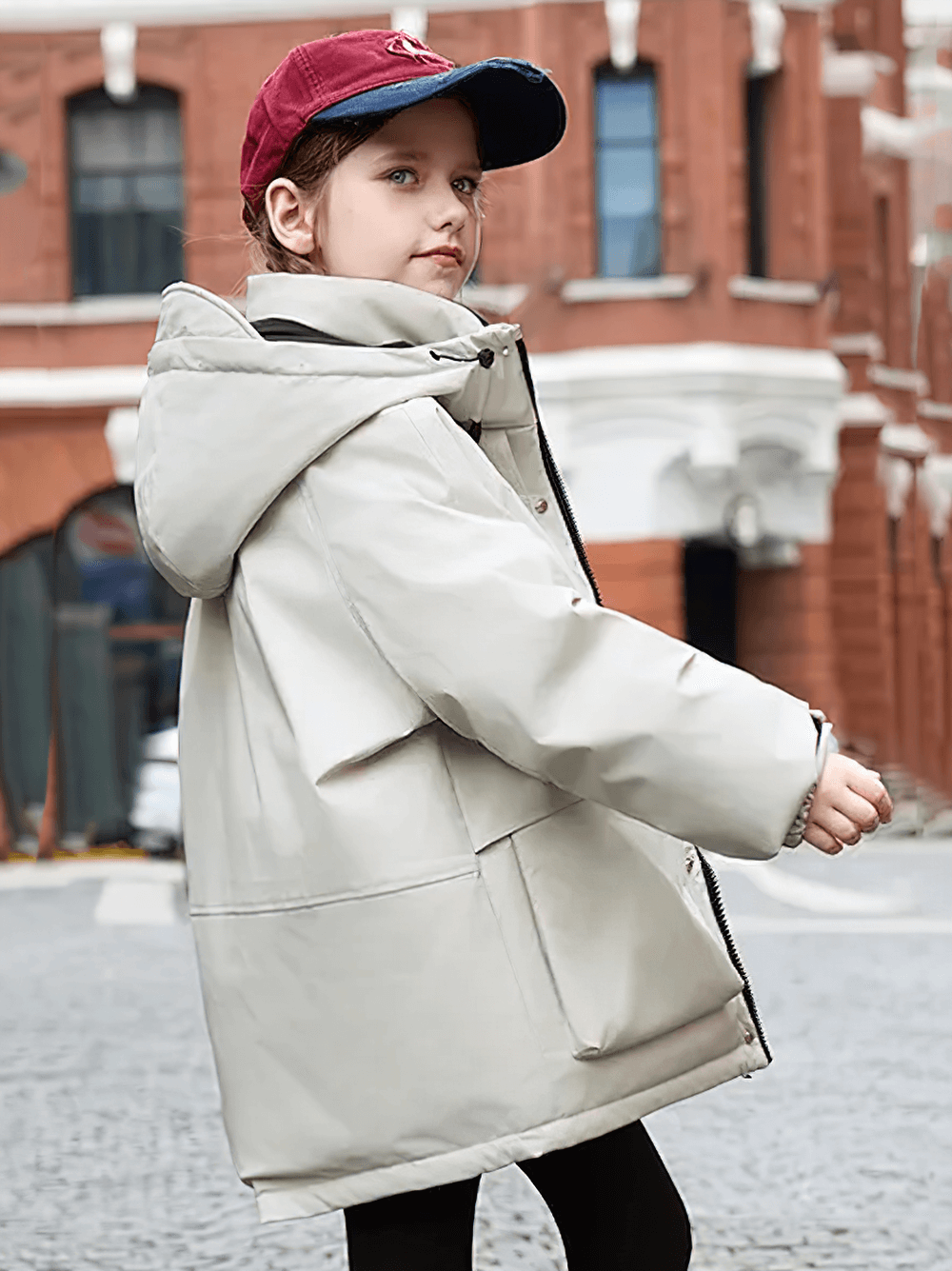 Child wearing Kids Waterproof Hooded Puffer Jacket with Pockets - SF3632, showing thick insulation and durable design in urban setting.