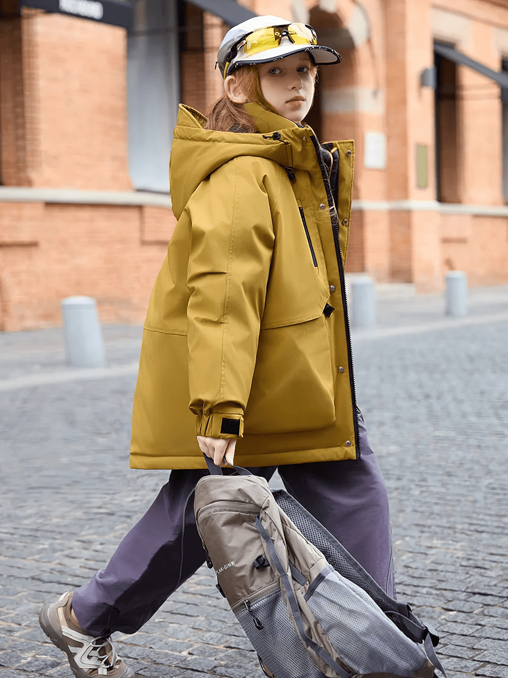 Child wearing Kids Waterproof Hooded Puffer Jacket with Pockets - SF3632, walking with a backpack on a city street.