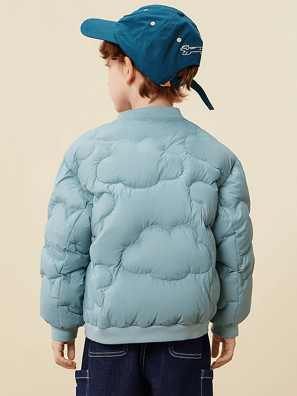 Back view of a child wearing the Kids Windproof Down Jacket with Cloud Design - SF3703, showcasing its quilted cloud pattern.