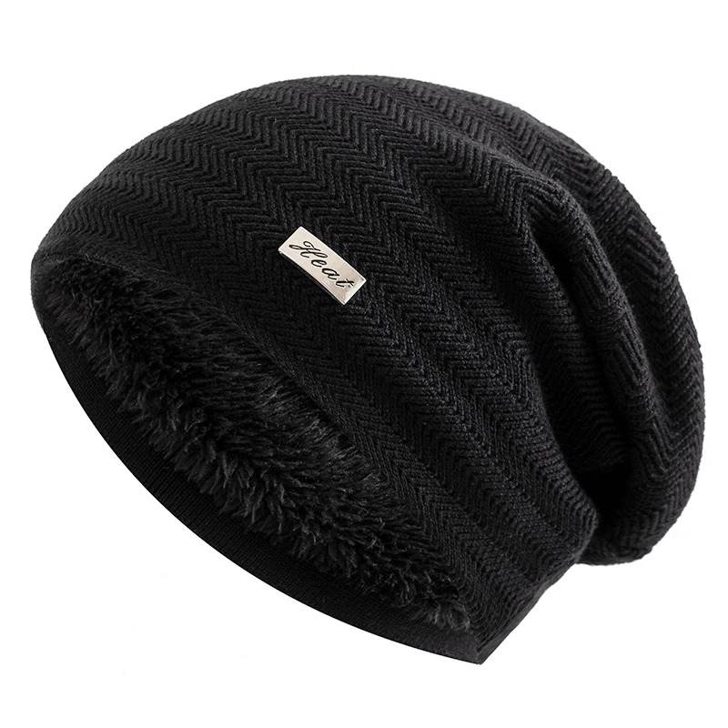 Unisex black knit beanie with fur lining, slouchy fit, and label decor, ideal for winter warmth and casual style wear.