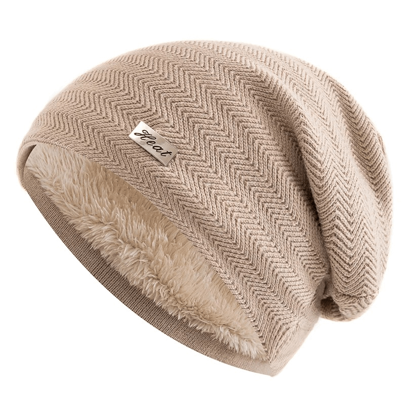 Unisex knit beanie with fur lining, slouchy fit, and label decor in solid beige pattern for cozy winter warmth and casual style.