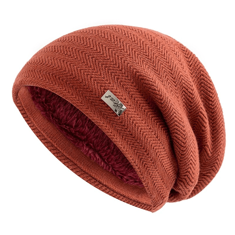 Unisex knit beanie with fur lining in orange, featuring a slouchy fit and label decor. Perfect for keeping warm in winter.