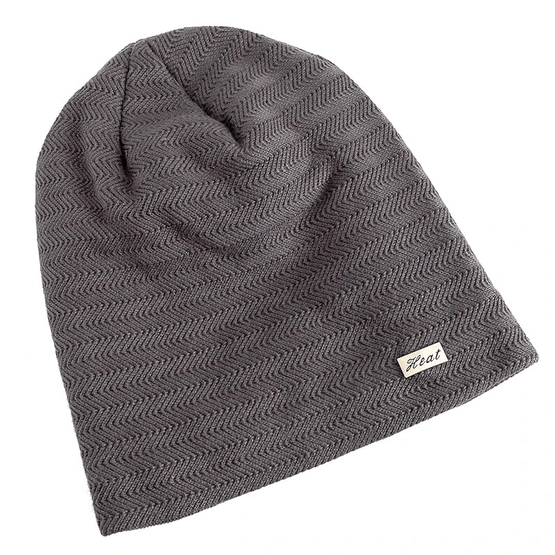 Gray knit beanie with fur lining for men and women, featuring a slouchy fit and stylish label, perfect for winter warmth and casual style.