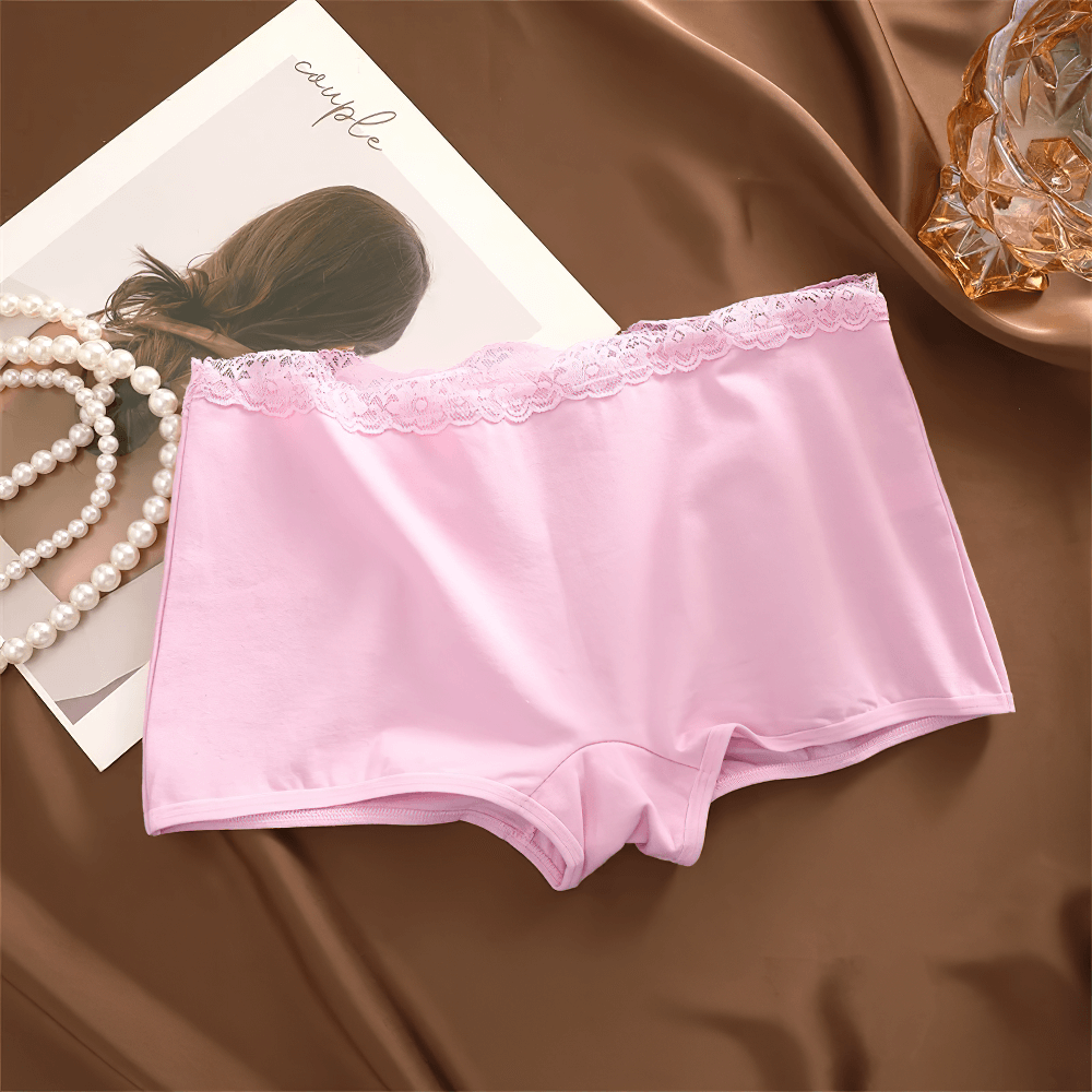 Soft pink lace trim boyshort panties on satin surface, showcasing elegance, comfort, and everyday wear style.