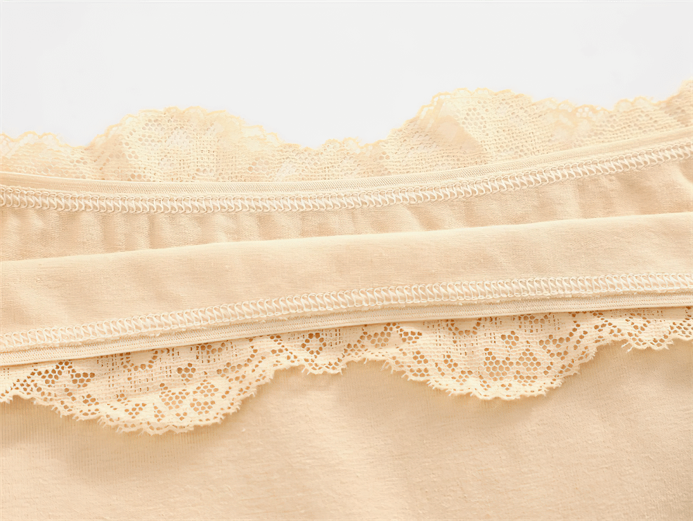 Close-up of beige lace trim boyshort panties showcasing soft, stretchy cotton fabric with delicate lace detailing for everyday comfort.