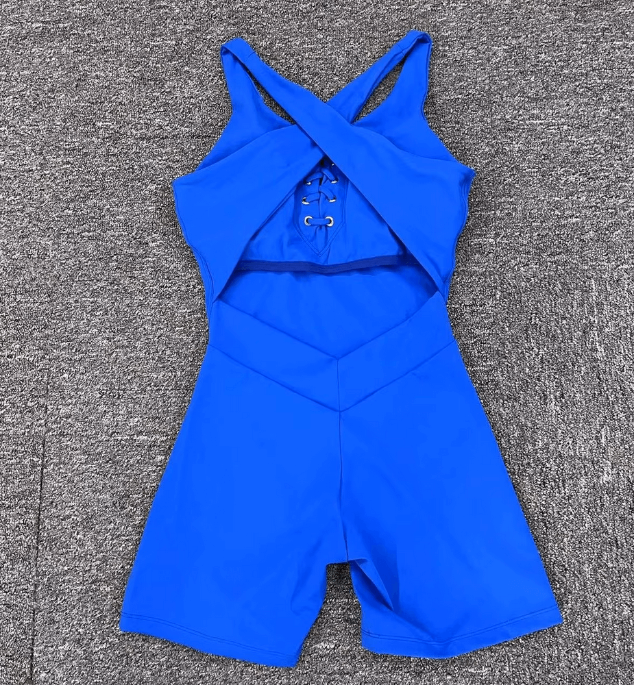 Blue lace-up sleeveless athletic jumpsuit for women, backless gym romper with breathable nylon fabric, ideal for active sports.